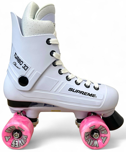 The Supreme Turbo 33 Nylon Quad Roller Skates feature a white boot with black accents, pink swirl wheels, and white laces. The stylish skates display the Supreme brand and stand out against a clean white background.