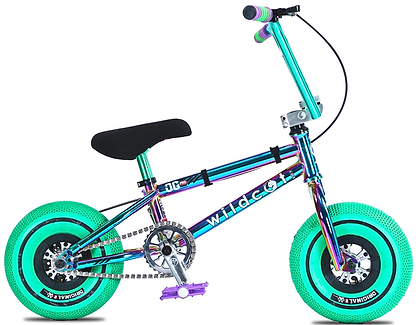 The Wildcat OG Pro Mini BMX Bike - Joker Green features a metallic blue and purple frame, bright green tires, black seat, purple pedals, Turbo wheel design, and "wildcat" branding on the frame.