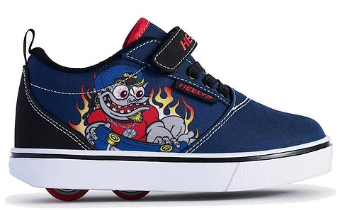 The Heelys Pro 20 Prints X2 Boys Shoes in navy and red feature wheels in the sole, a cartoon character with a skateboard and flames, a black "Heelys" strap, and a white sole. Brand: Heelys.