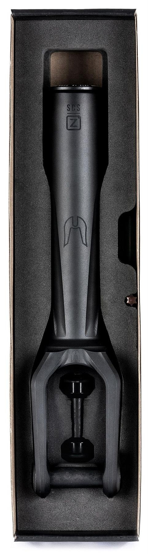 The Ethic DTC Merrow V3 8/12STD SCS Stunt Scooter Forks in black by Ethic come fitted in foam inside a cardboard box, showing the steerer tube and fork crown with engraved logos and markings.