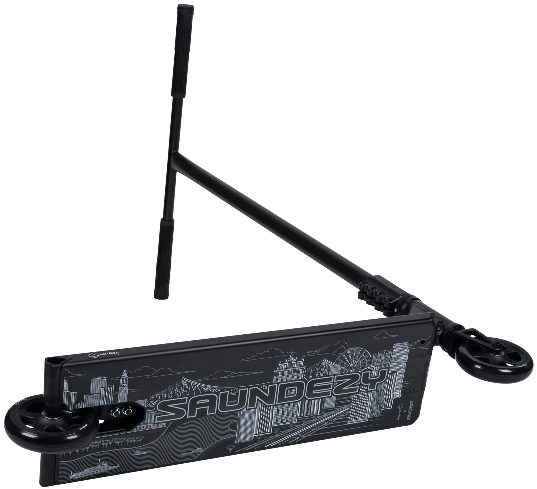The Drone Nexus Kai Saunders 'Saundezy' Signature Stunt Scooter in black features a cityscape deck design, foldable handlebars, and visible wheels.