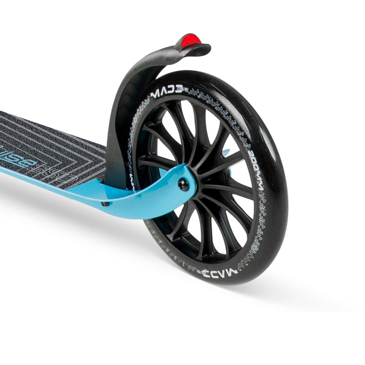Close-up of the rear wheel on the Madd Gear Metro Cruise 250 Foldable Commuter Scooter (Black/Blue) by Madd Gear (MGP), featuring a large black tire with white text, a red reflector, and a textured striped deck for added grip.