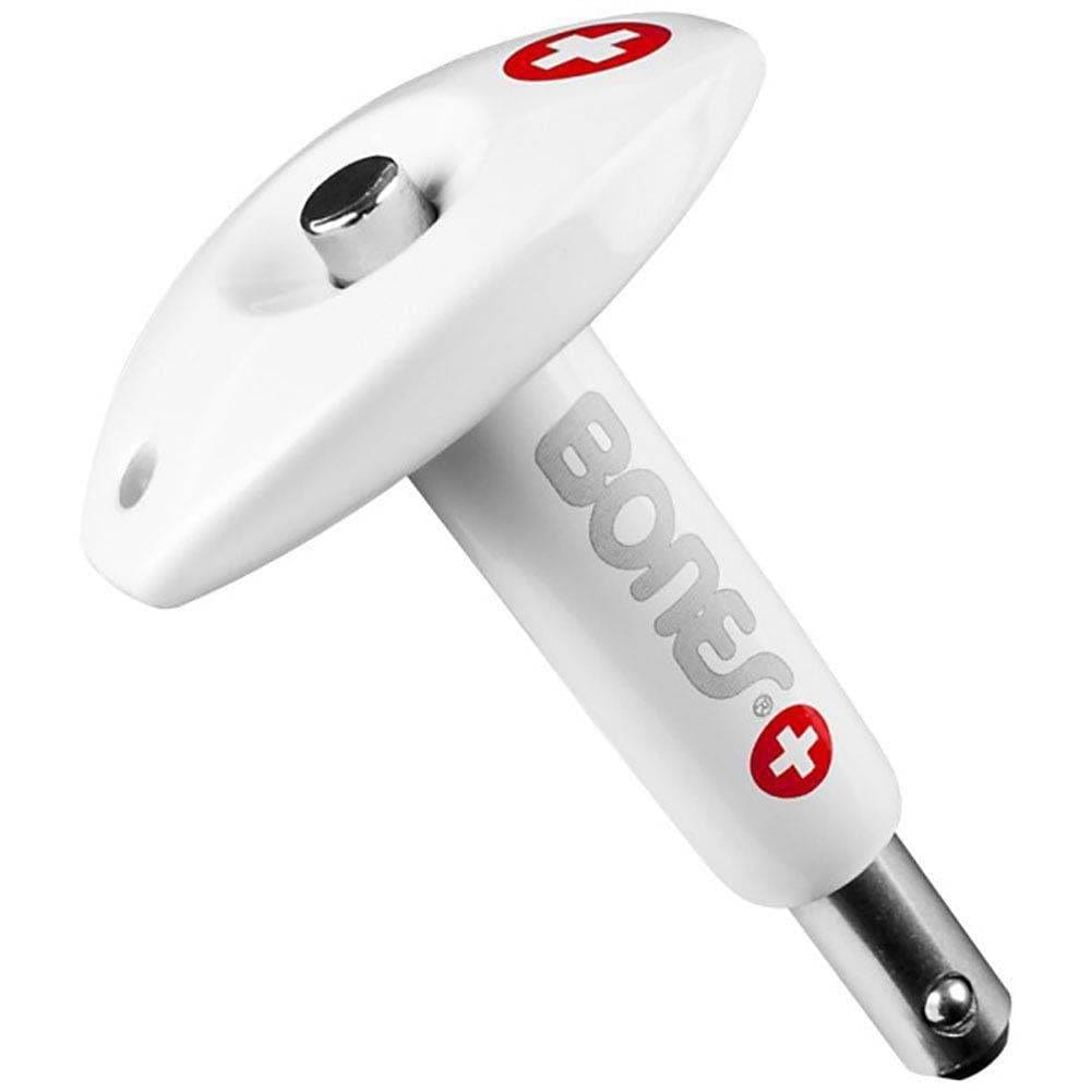 The Bones Skateboard Bearings Tool - White features a T-shaped design with a metal tip, red and white cross symbols, integrated bearing press functionality, and the "Bones" logo printed on one side, offering an innovative blend of style and performance.