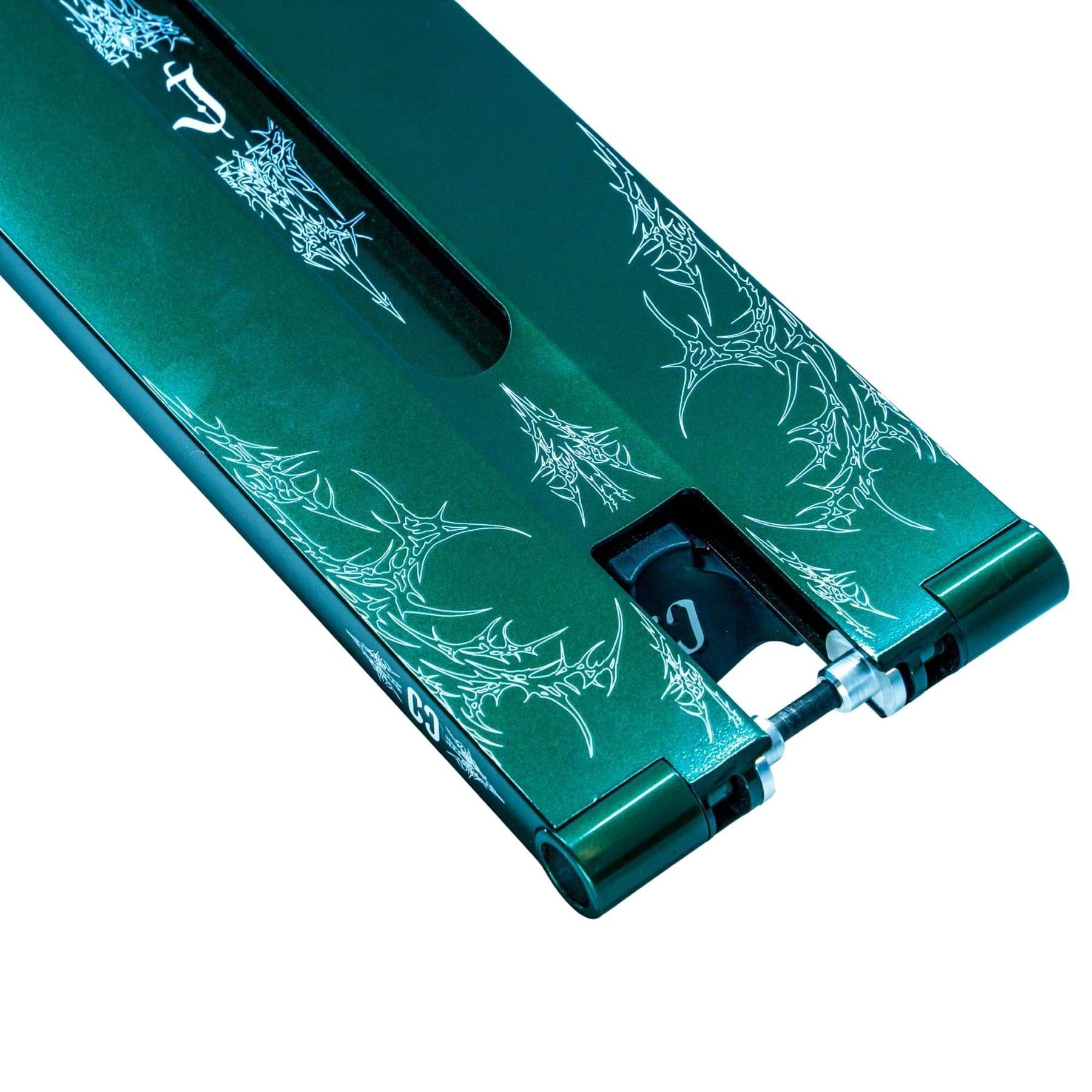 Close-up of the CORE ST3 Forged Green J.Matthews Signature Street Stunt Scooter Deck (6.5" x 22.5") by CORE, showcasing white graphic designs on green and a visible black rear wheel.