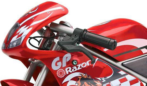 Close-up of the Razor Pocket Rocket Electric Bike - Red, featuring white graphics and logo on the front fairing and handlebars, with visible brake lever and part of the seat—this sleek kids' racing bike is from Razor.