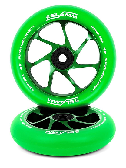 Two green Slamm Team 110mm stunt scooter wheels, featuring aluminium cores with black spokes and hubs. Both have high-rebound PU and white SLAMM branding—one stands upright, the other lies flat below.