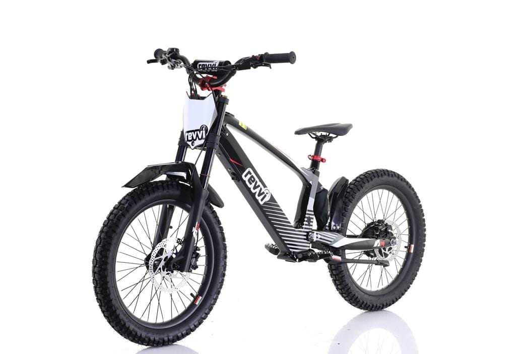 The Revvi 20" Kids Electric Balance Bike - Black features thick off-road rubber air-filled tires, a sturdy frame, front suspension fork, rear coil shock absorber, and a branded front plate. Its sporty design is ideal for trail riding.