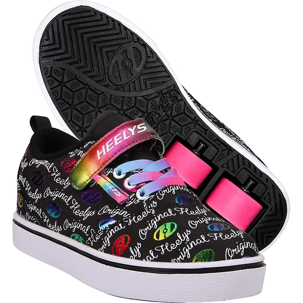 A pair of Heelys Pro 20 X2 Girls Shoes by Heelys in black, white, and rainbow with "Heelys Original" text, colorful logo print, rainbow laces, nylon upper, and pink low-profile wheels—one shoe upright, one showing the wheel and sole.