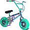 The Wildcat OG Pro Mini BMX Bike - Joker Green by Wildcat features a small metallic frame with "WILD CAT" on the side, bright teal turbo-style tires, purple pedals, and green and purple handlebar grips.