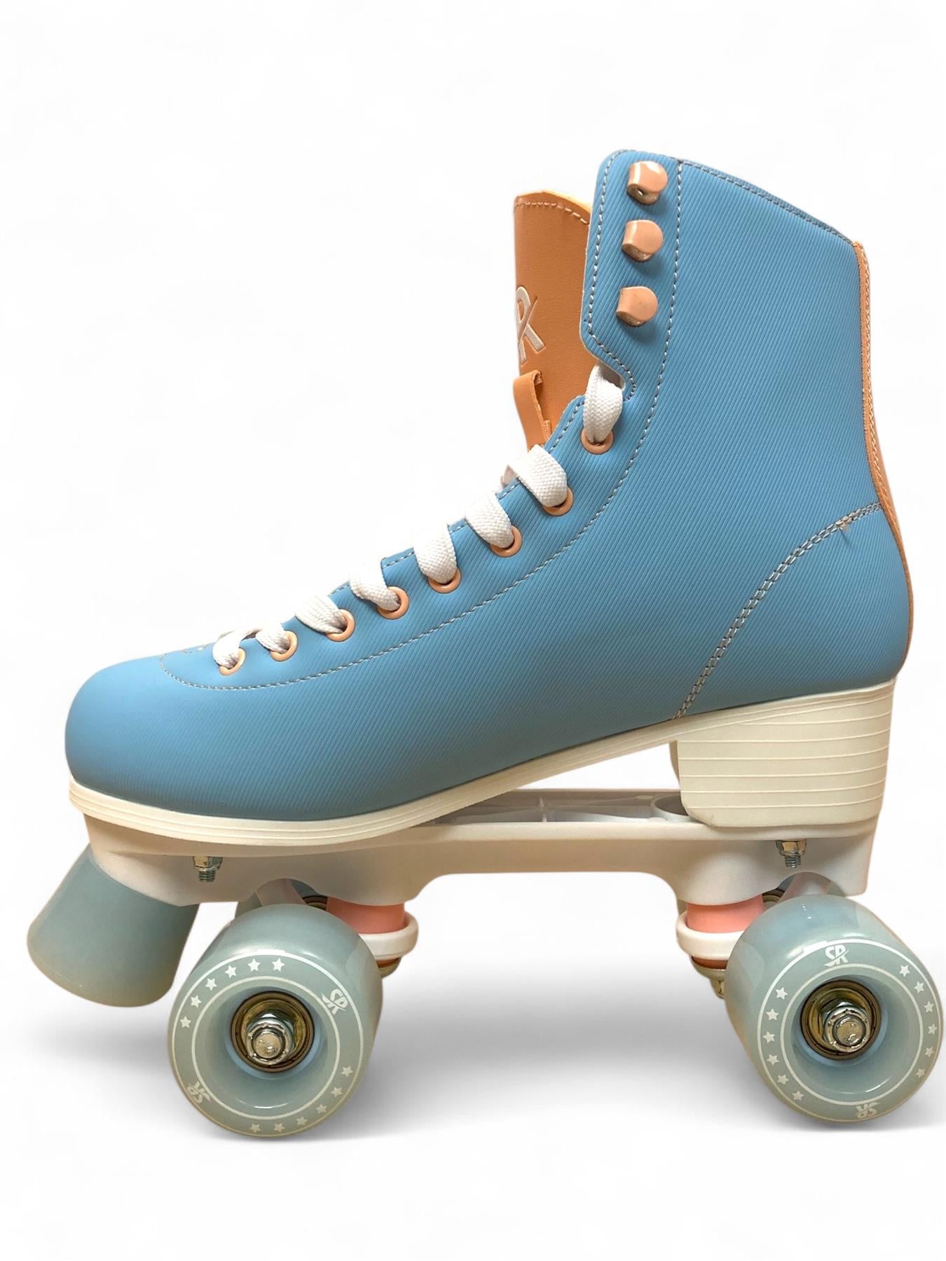 The Supreme Malibu Quad Roller Skates - Light Blue feature retro styling with white laces, tan accents, four light blue wheels, a blue toe stop, and a white sole—ideal for beginners or recreational skating.