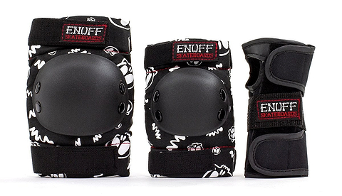 Explore the Enuff Skulls Junior Ramp Skate Protection Pad Set in black, designed with comfort padding for skateboarders. This set includes knee and elbow pads, along with wrist guards, all featuring striking white graphic designs. Each piece is adorned with a red and black "Enuff Skateboards" patch for extra style.