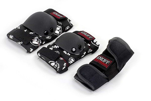 The Enuff Skulls Junior Ramp Skate Protection Pad Set in black provides a fashionable combination of protective gear, including knee pads, elbow pads, and wrist guards decorated with a distinctive black and white design. Enhanced with comfort padding for additional ease and featuring a red "ENUFF" label, this set offers secure yet stylish protection.