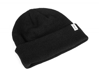 The Ethic DTC Serpico Beanie - Black is a classic knit beanie featuring a folded cuff and a small white tag on the cuff with "ETHIC" boldly displayed in black. This staple from Ethic apparel effortlessly combines style and comfort.