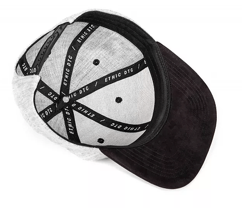 The Ethic DTC Snapback Cap - Deerstalker Grey showcases an embroidered Ethic logo and delivers a timeless snapback style. Inside, "ETHIC DTC" is printed on the inner lining, while the sophisticated gray and black color combination enhances its chic black visor and noticeable stitching details.