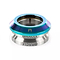 The Ethic DTC Oracle Integrated Stunt Scooter Headset in Neochrome features a metallic, smooth, slightly conical design. The upper section displays a gradient of blue and purple hues, while the lower part is silver with the "RACEFACE" engraving. This headset is built to withstand heavy landings, making it ideal for stunt scooter enthusiasts seeking durability.