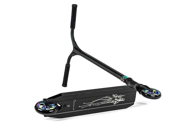 The Ethic DTC Erawan V2 Complete Stunt Scooter (S) in Neochrome is pictured with its deck resting on the ground and handlebars leaning against it. This lightweight scooter features vibrant wheel hubs and a stylized design on the underside of the deck, complemented by an IHC compression system for smooth rides.