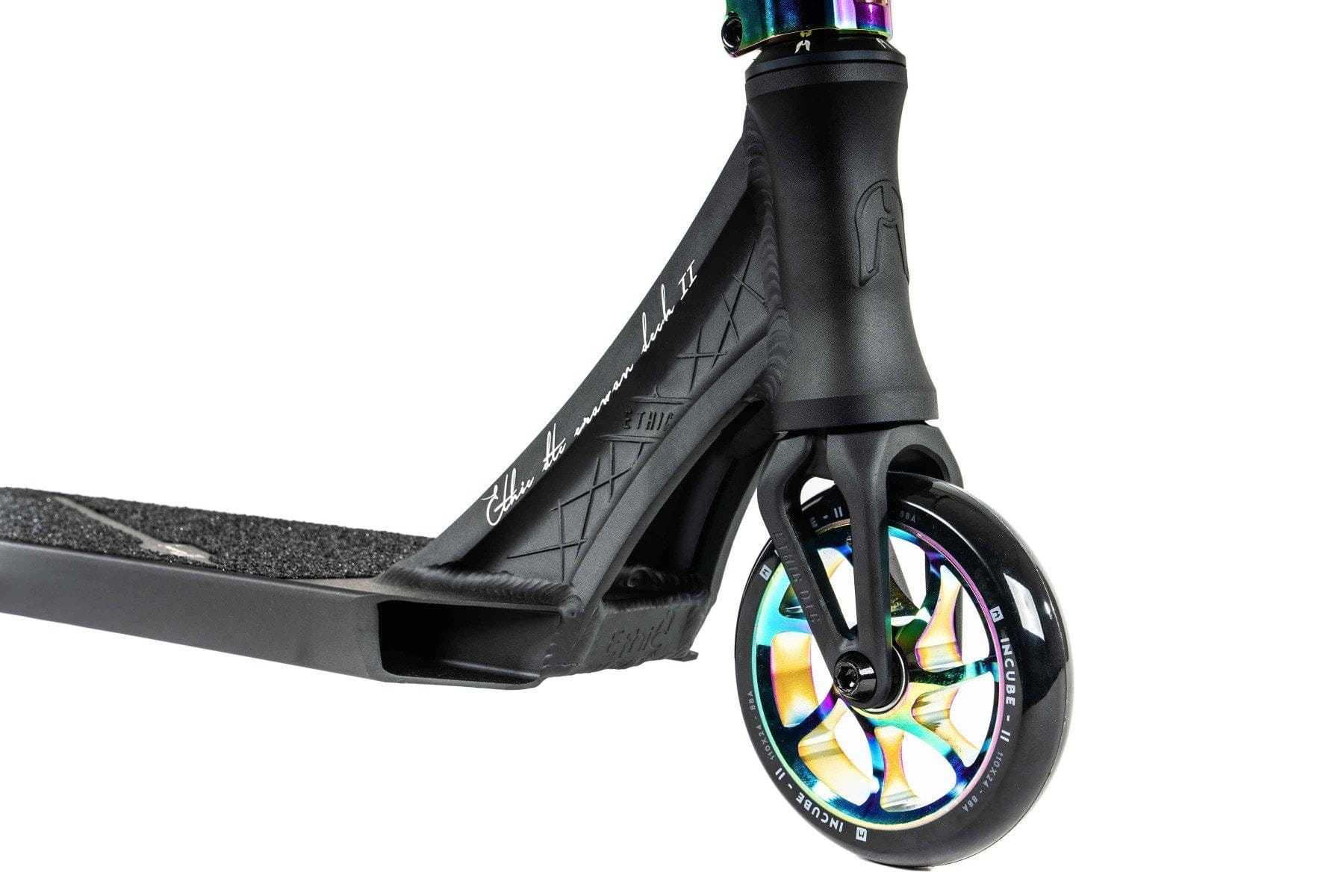 A detailed view of the Ethic DTC Erawan V2 Complete Stunt Scooter (S) - Neochrome highlights its front wheel and deck. The wheel sports a vibrant, iridescent design, while the deck is equipped with a textured grip and branding. The fork and neck are sleek and robust, featuring IHC compression for enhanced performance.