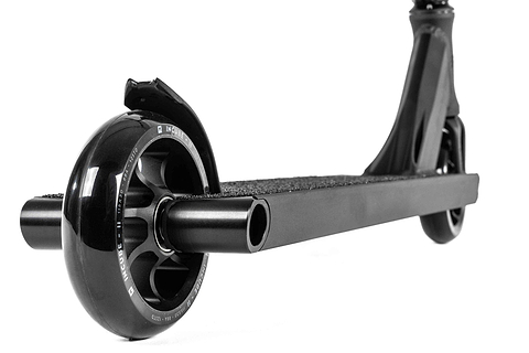Close-up of the rear wheel and deck of the Ethic DTC Pandora Complete Stunt Scooter (L) in black. The large, glossy wheel complements the textured, non-slip deck. Positioned at an angle, it highlights its sleek design and rugged Chromoly steel T-bar, making it perfect for street riding enthusiasts.