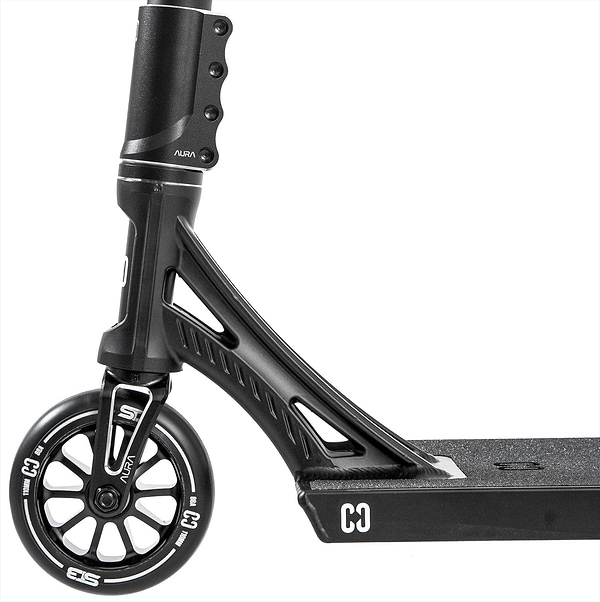 Close-up side view of the CORE ST3 Complete Stunt Scooter in black, highlighting the front wheel, fork, and textured deck. Visible CORE brand markings emphasize its pro-grade components on the wheel, fork, and deck.