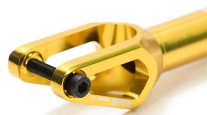 Close-up of the Dare Dimension IHC Stunt Scooter Forks in gold, featuring a shiny CNC-machined aluminium finish, black bolt, and brand logo—designed for reliable IHC compression on stunt scooters.