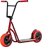 The Rocker Rolla Big Wheel Complete Scooter - Red by Rocker is designed with a striking red and black color scheme and equipped with thick, bright orange tires for enhanced stability and off-road capabilities. Like mini BMX bikes, it features a robust frame and a wide footboard. The handlebars are black with red grips, making it ideal for adventurous rides.