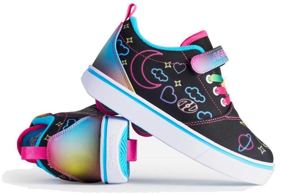 Two Heelys Pro 20 Prints X2 Girls Shoes by Heelys in Black/Hot Pink/Multi, featuring neon heart, star, and planet designs. One shoe is upright; the other shows a pink, teal, and yellow gradient heel and white soles.