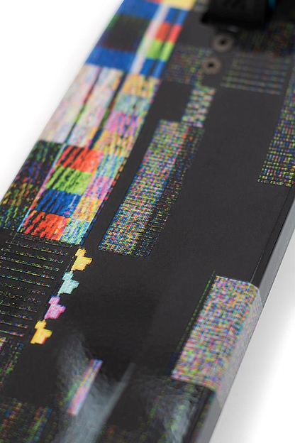 Close-up of a skateboard deck showcasing a modern design with multicolored geometric and pixelated patterns on a glossy black surface. The vibrant abstract visuals resemble the Nebula Wrap seen on the Slamm Mischief Complete Stunt Scooter - Glitch by Slamm, designed for high-end performance.