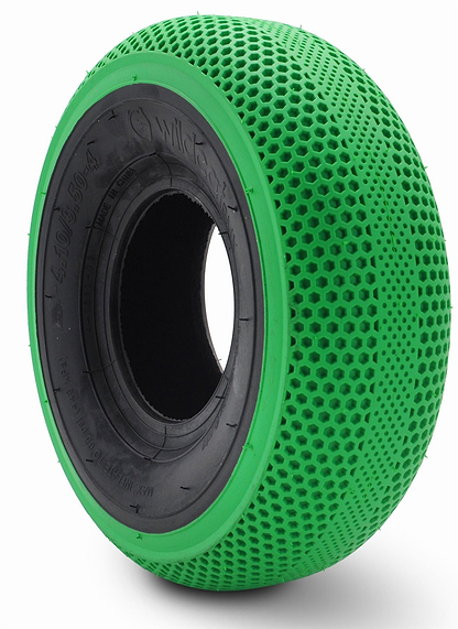 A close-up of a green, honeycomb-patterned solid tire with a black inner hub, designed for the Wildcat OG Pro Mini BMX Bike - Joker Green Hulk by Wildcat. The surface has hexagonal holes and a Turbo wheel design for durability and cushioning.
