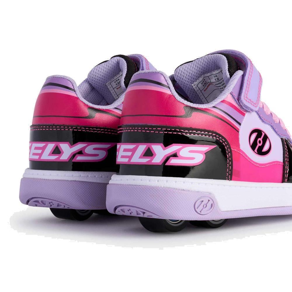 A close-up of the back of two Heelys Rezerve Low X2 Girls Shoes in Black, Purple, and Pink shows the two-wheel design in the heels, bold Heelys branding, and logo on the sides.