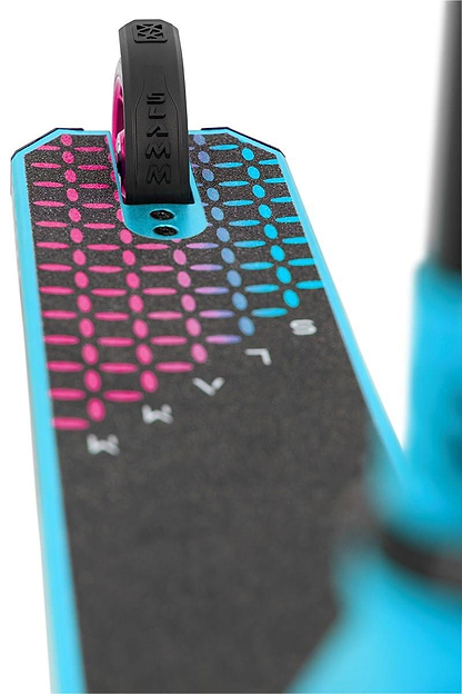 A close-up of a scooter deck shows black grip tape with a vibrant geometric pattern of pink and blue dots. The front wheel, part of the blue frame, and the Slamm Nylon Stunt Scooter Flex Fender - Black are visible, ideal for your stunt scooter brake needs.
