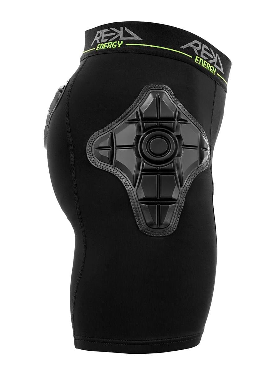The REKD Energy Pro Impact Skate Protection Shorts - Black by REKD feature a large, textured energy foam hip pad and a waistband with bold "REKD ENERGY" branding in white and neon green. Shown side-on, worn by a mannequin.