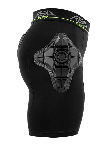 The REKD Energy Pro Impact Skate Protection Shorts - Black by REKD feature a large, textured energy foam hip pad and a waistband with bold "REKD ENERGY" branding in white and neon green. Shown side-on, worn by a mannequin.