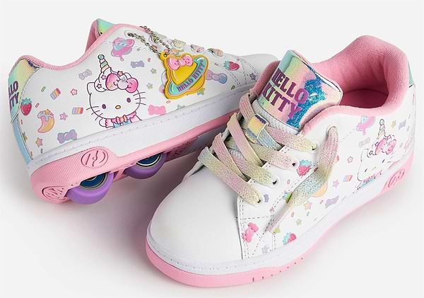 The Heelys x Hello Kitty Split X2 Girls Heelys in White/Pink feature pastel rainbow laces, a unicorn design, pink soles, purple heel wheels on one shoe, cute decorations, and a shiny Hello Kitty tongue label.
