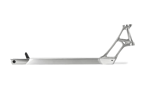 The Ethic DTC Pandemonium V2 Raw Stunt Scooter Deck features a sleek metallic finish with an intricately crafted neck and is constructed from 6061-T6 aluminium. Its flat base and cut-out sections enhance its lightweight structure, presenting a simple elegance on a white background.