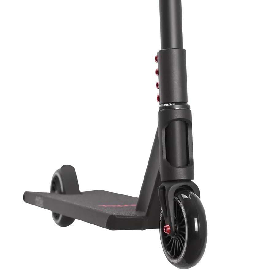 Close-up of the Aztek Siren Complete Street Stunt Scooter in black, showing the deck, rear and front wheels, and lower handlebar with red accent bolts. Brand: Aztek.