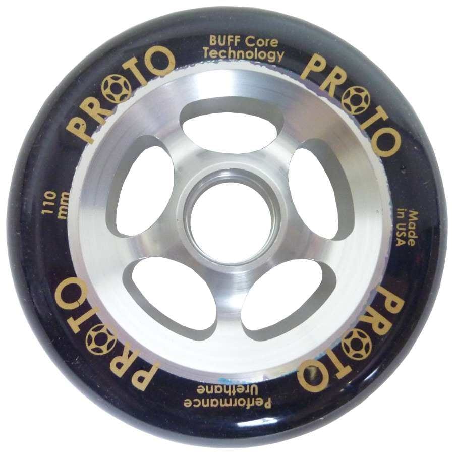 A close-up of the Proto Gripper 110mm Stunt Scooter Wheel showcases a sleek metal core with a black outer ring. The wheel features "PROTO," "BUFF Core Technology," "110 mm," and "Performance Urethane" elegantly printed in gold. This high-performance scooter wheel is expertly crafted in the USA for superior quality.