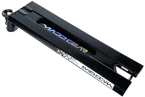 Madd Gear MGP MGX Black Stunt Scooter Deck – 5.5″ x 20.5″, featuring a white logo, cutout center, and visible rear wheel bolt area on the left side; the underside displays a crackle pattern near one end, making it ideal for park and street riding.