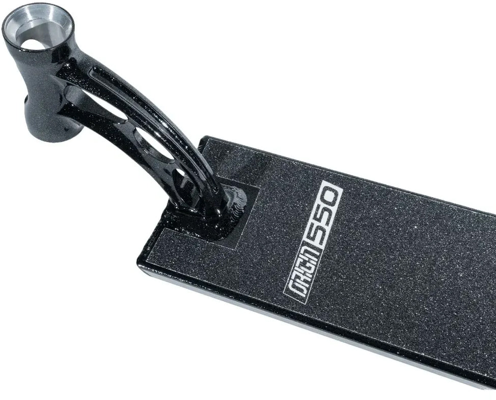 Close-up of the Madd Gear MGP VX Origin Black Stunt Scooter Deck, featuring a textured surface and “550” marking. The image highlights the rear end and part of the neck, showcasing its curved, hollow design where the handlebar attaches—ideal for park riders who value both durability and style. This premium 5.5″ x 20.5″ deck from Madd Gear (MGP) is built for high performance.