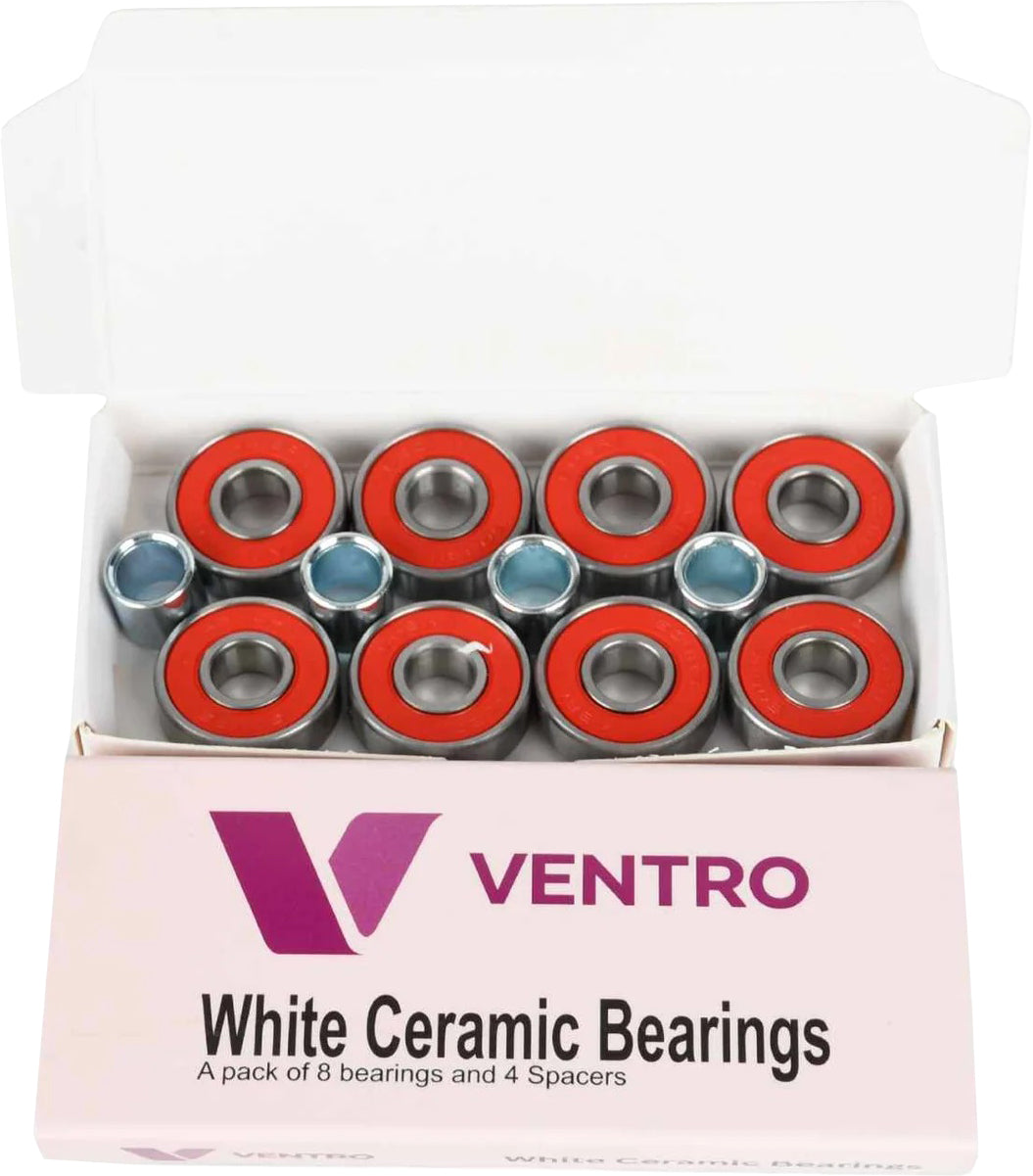 An open box labeled "Ventro Ceramic ABEC 11 Red Bearings - Set of 8" from Ventro contains eight red-sealed ceramic skateboard bearings and four silver spacers, all neatly arranged inside the packaging. These precision-engineered ABEC 11 bearings come in the popular 608 size, ensuring a smooth and reliable ride for any skateboard setup.