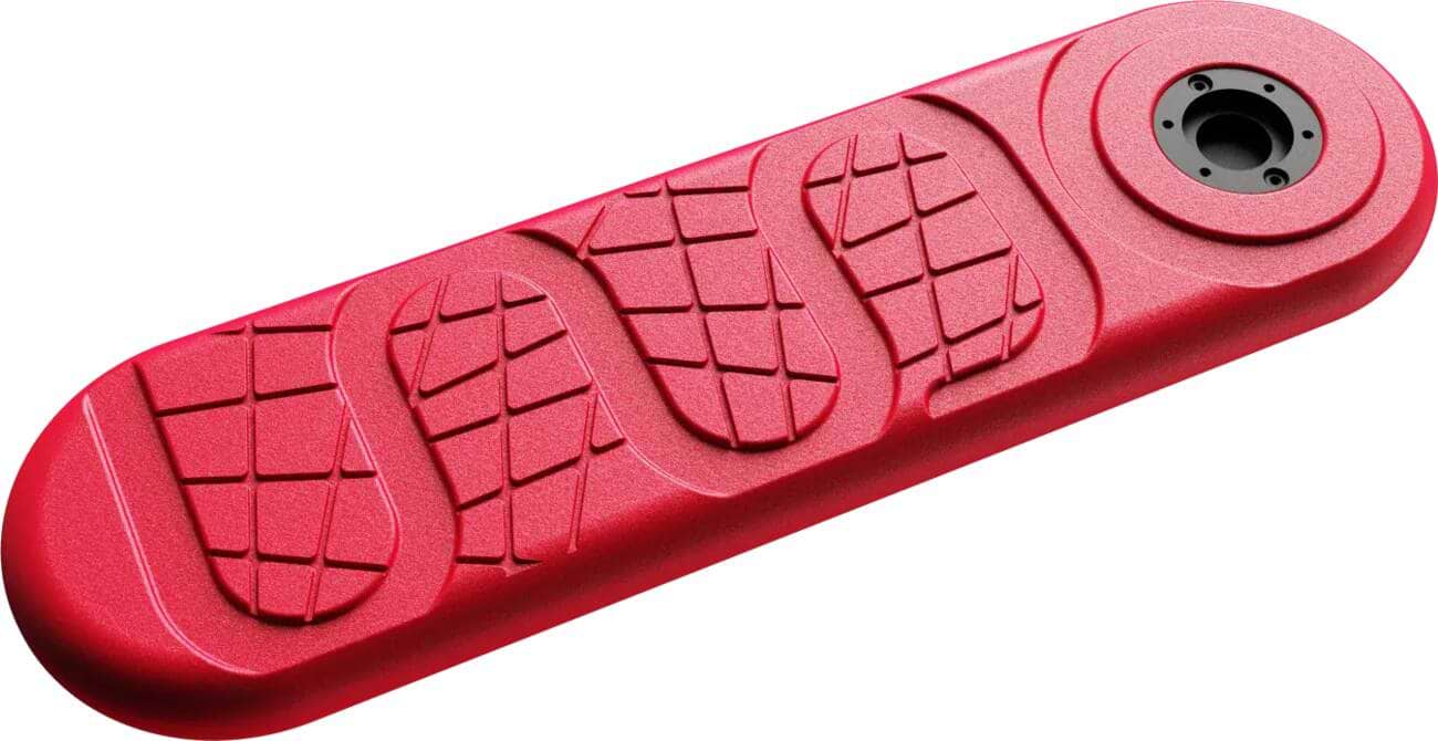 The INDO X70 Trampoline Scooter Deck - Red Rocker, by INDO, is a red, elongated rectangular deck with a circular attachment on one end and a textured, wavy pattern across its surface. It's an ideal replacement deck for your INDO scooter.