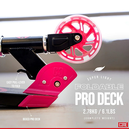 Close-up of the CORE Foldy Kids LED Foldable Scooter in black and pink. The image highlights features such as an easy pull-lever for folding, a boxed pro deck, and an adjustable handlebar. Text reads "Super Light Foldable Pro Deck, 2.78 kg / 6.1 lbs (Complete Weight).