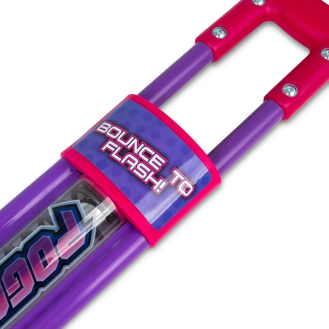 Close-up of the Ozbozz Go Light Up Kids Pogo Stick - Pink by Ozbozz, featuring purple handles and pink accents. The label reads "BOUNCE TO FLASH!"—a fun light-up pogo stick perfect for kids.