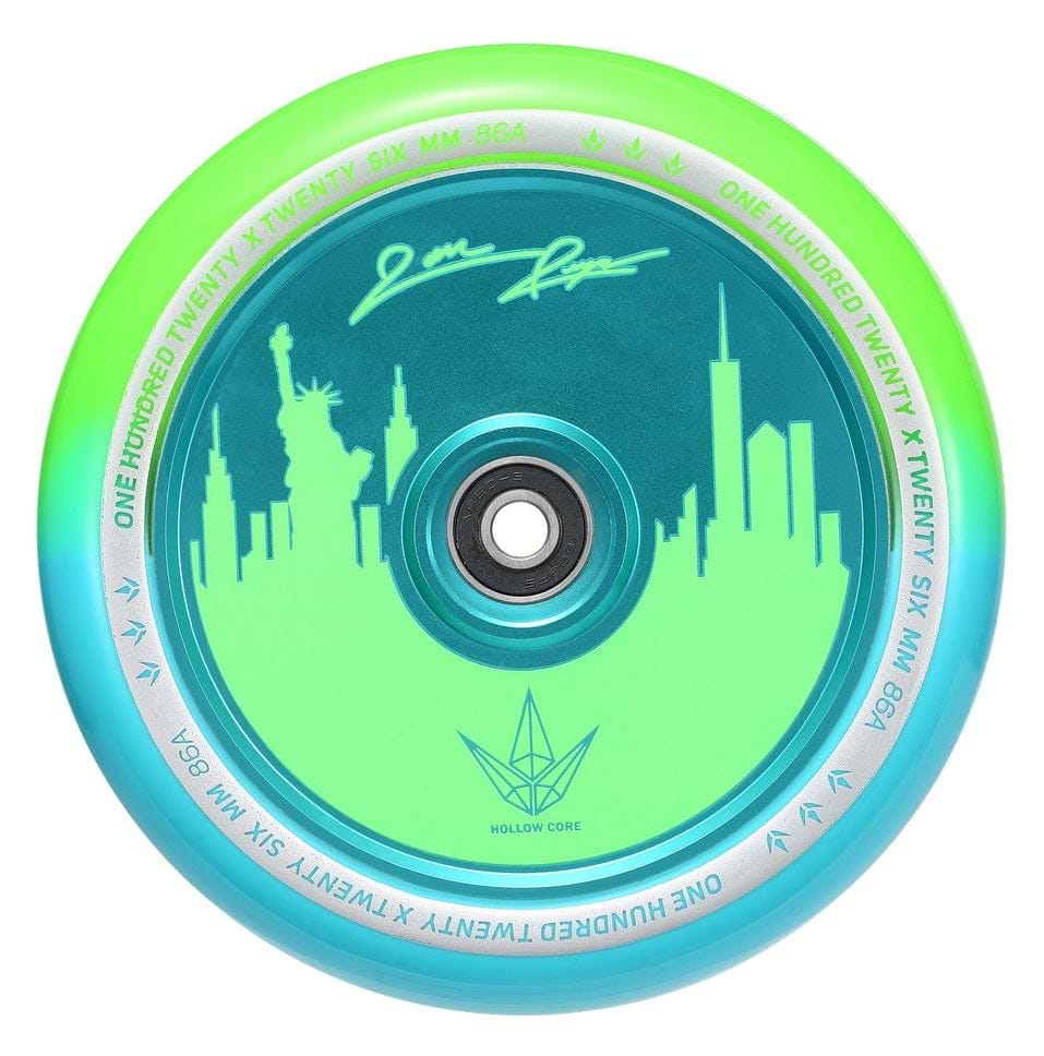The Blunt Envy 120mm Jon Reyes Signature Hollow Core Stunt Scooter Wheel, designed in a dynamic green and teal color scheme, features an intricate city skyline that includes the Statue of Liberty. It showcases Jon Reyes' Signature with advanced Hollowcore Technology and has "One Hundred Twenty Six MM 86A" beautifully inscribed on the inner ring.