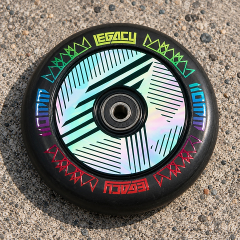 Legacy Ventus 1.5 Pro 110mm Stunt Scooter Wheel in neochrome, featuring a black rubber tire and a hollow core with geometric patterns and colorful text accents.