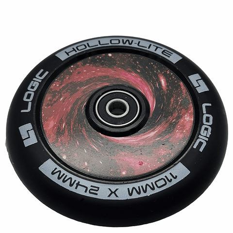 The Logic Hollow Lite 110mm Stunt Scooter Wheel - Vortex Red features a striking galaxy design in the center, showcasing swirling pink and red patterns. This black wheel is branded with "LOGIC" and incorporates the advanced Hollow Lite technology, marked as "HOLLOW-LITE" and measuring "110MM X 24MM." It also includes ABEC 11 bearings for an exceptionally smooth ride.