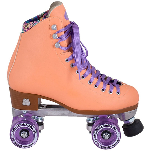 Introducing the Moxi Beach Bunny Quad Roller Skates in a charming peach color from Moxi. These animal-friendly skates feature eye-catching purple laces and wheels. The boot is adorned with decorative stitching and showcases a patterned interior lining, reminiscent of the popular Beach Bunny series by Moxi Skates. Complemented by a brown sole and durable metal base, these skates deliver exceptional style and durability on four wheels.