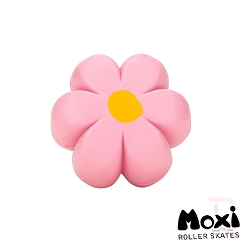 The Moxi Brake Petal Roller Skate Toe Stops - Pink Carnation features a pink flower shape with a yellow center, and the brand name, Moxi, suggests it belongs to their Brake Petal Toe Stops collection.