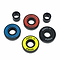 Four vibrant skateboard bearings from the Logic ABEC 11 Multi Colour Scooter Bearings - 4 Pack are displayed on a white background, highlighting their premium quality. The set includes bearings in striking red, yellow, blue, and black colors. Accompanying these high-performance essentials for your ride are two black cylinder spacers.