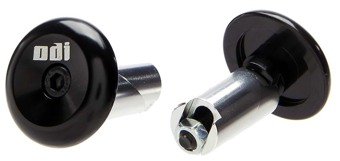 Close-up image of two ODI Aluminium Stunt Scooter Bar Ends in black. One is upright, showcasing the branded head with an Allen key bolt, while the other is tilted to reveal the durable fastening mechanism. Ideal for upgrading your handlebars with premium ODI scooter accessories.