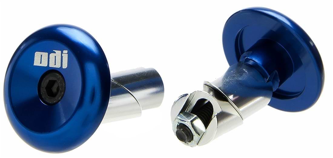 Displayed are two ODI Aluminium Stunt Scooter Bar Ends in blue. One bar end is standing upright showcasing the ODI logo, and the other is positioned on its side, exposing the bolt and mounting mechanism. Ideal for those who desire both style and durability in their handlebar accessories.